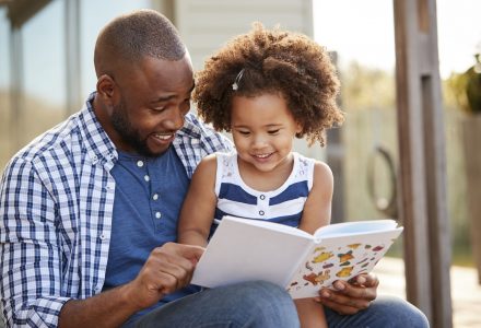 Why Readingmate App Exists Blog Post - image of a black father reading to his daughter