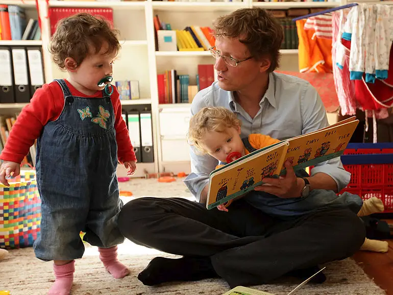 Parent reads at home with children