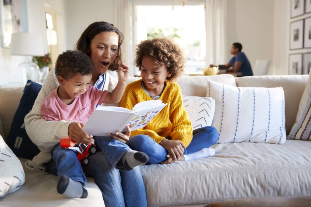 Parent and children read at home together