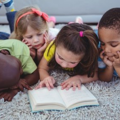 Children reading a book together