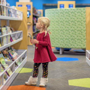 girl looking at books in a library